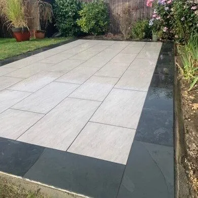 large stone patio with dark edge detailing