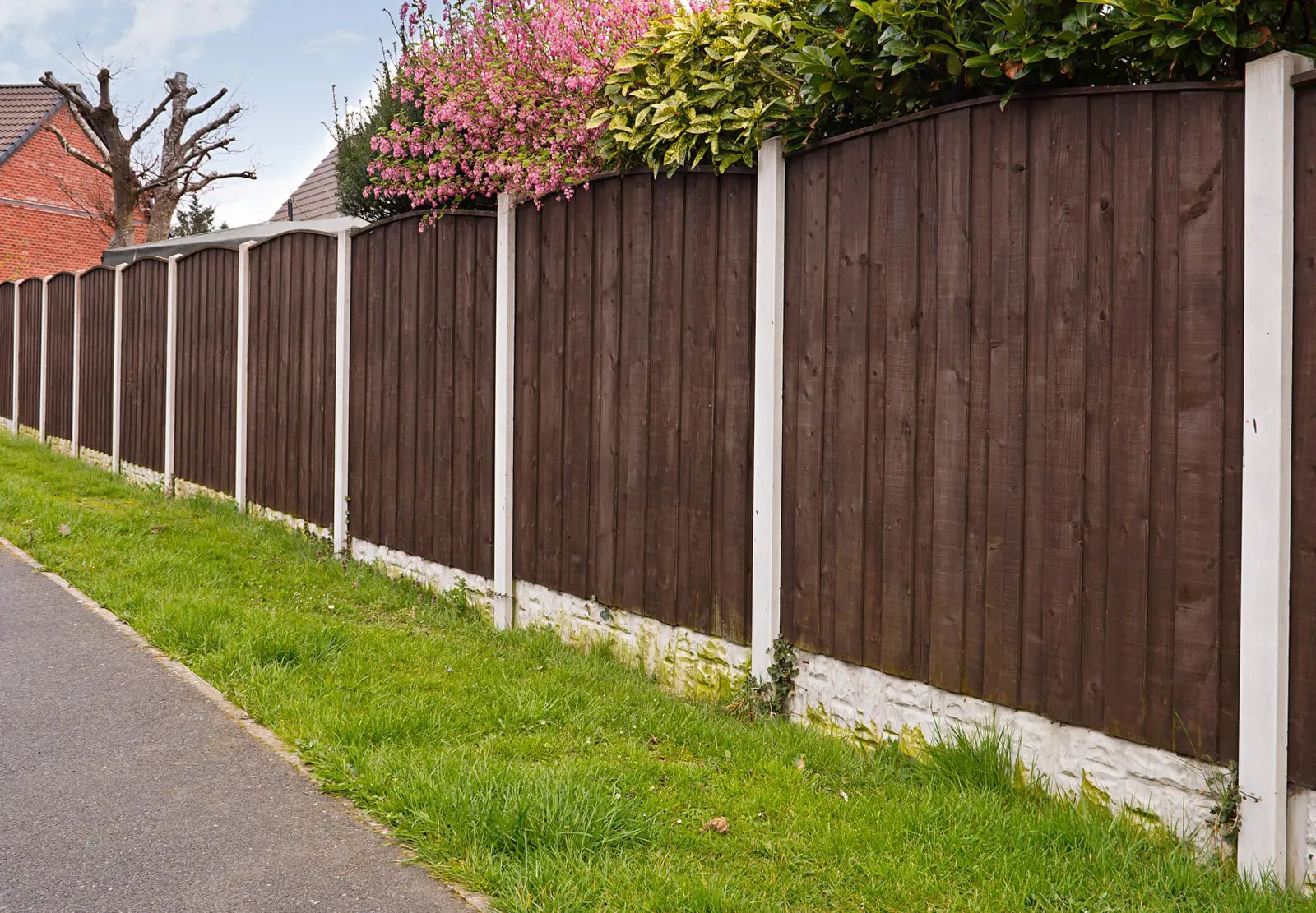 Close board fence erected around a garden for privacy with wooden fencing panels